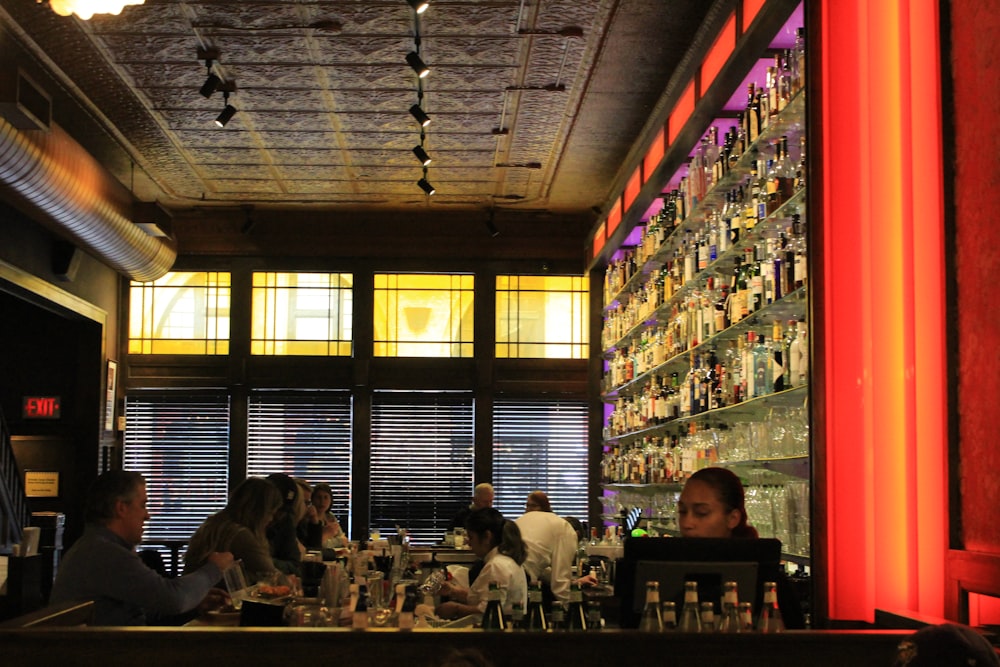 a group of people sitting at a bar