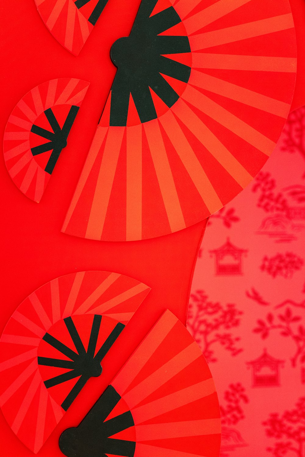 a close up of a red paper with black designs on it