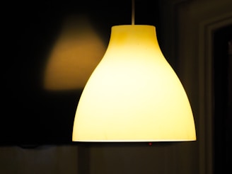 A striking modern pendant lamp glowing warmly in a cozy living room.