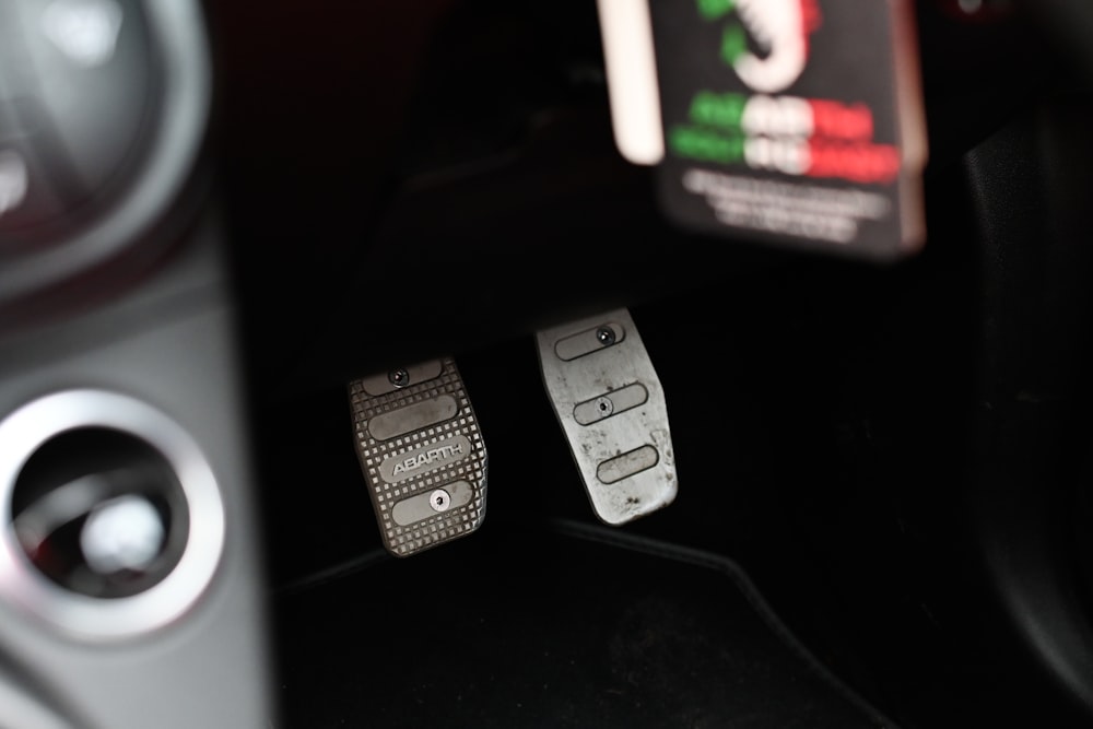 a close up of metal car pedals