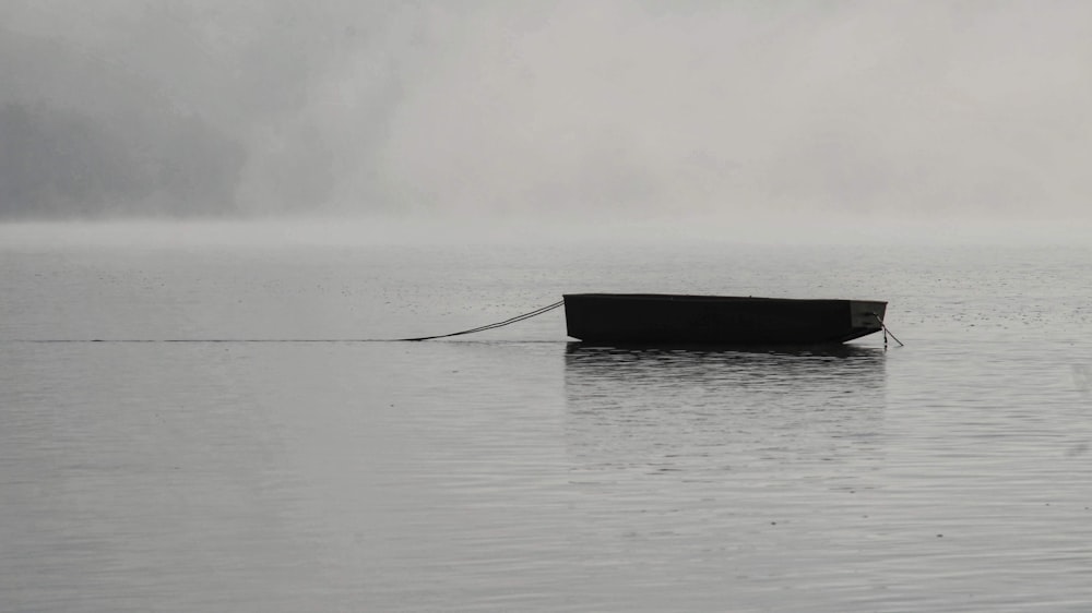 a small boat floating on top of a large body of water