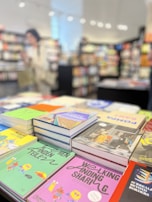 Stack of colorful e-books and guides available in the upseller digital store.