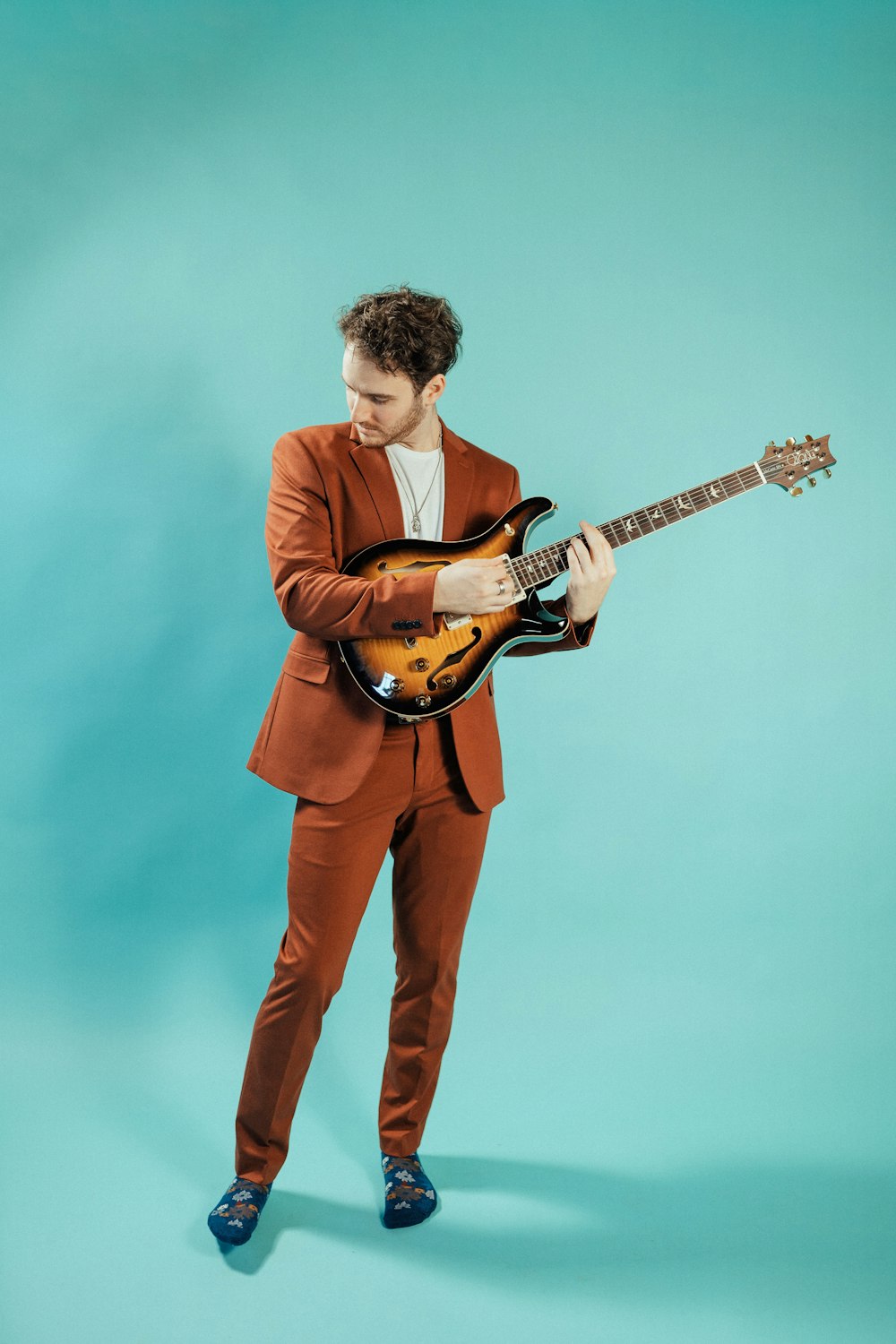 a man in a suit holding a guitar