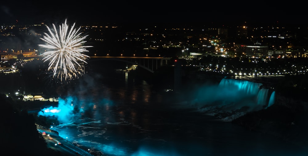 a fireworks display over a city at night