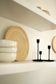 a shelf with plates and bowls on top of it