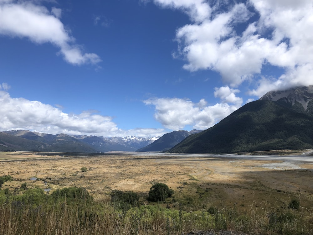 a view of a valley with mountains in the background