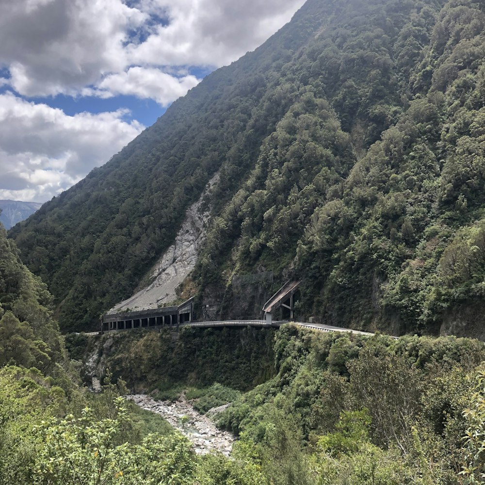 a scenic view of a mountain with a road going through it