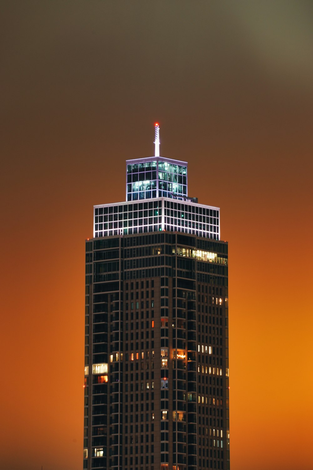 a very tall building with a very bright sky in the background