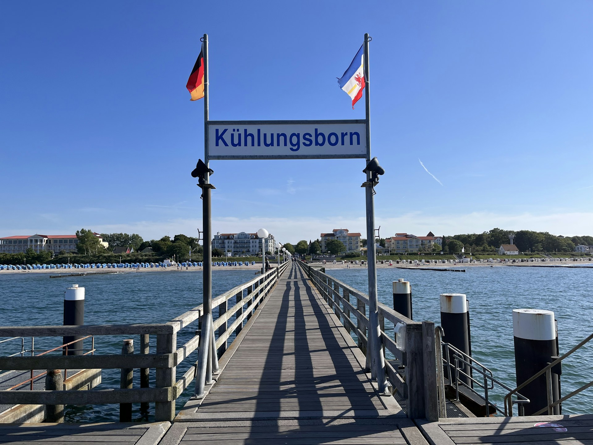 a wooden pier with a sign that says kuhlungsborn