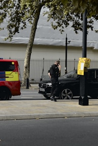 Professional security personnel standing confidently beside a VIP transport vehicle.