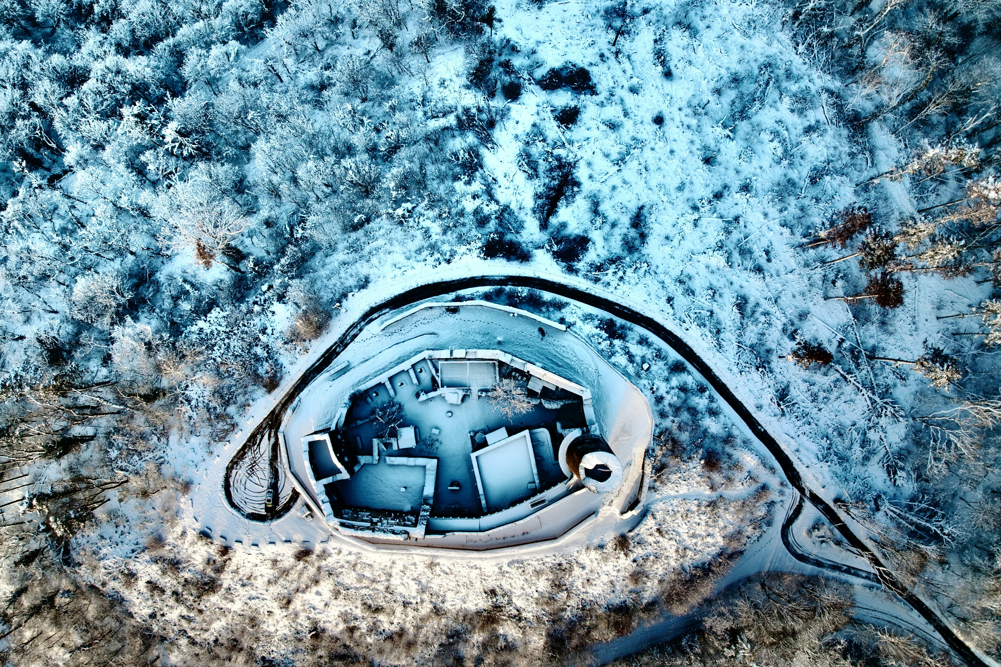 An aerial view of a building in the snow