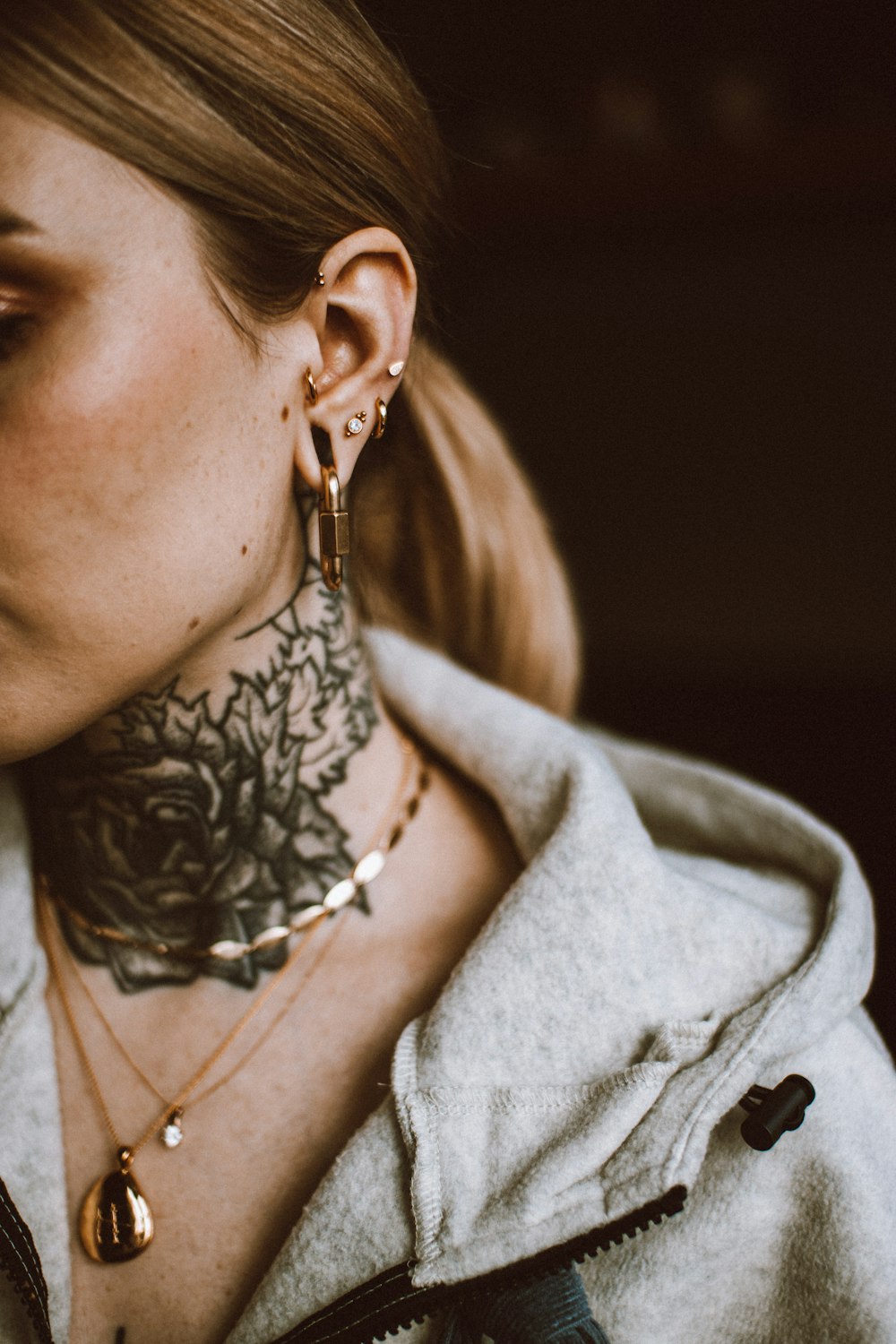 a woman with a tattoo on her neck