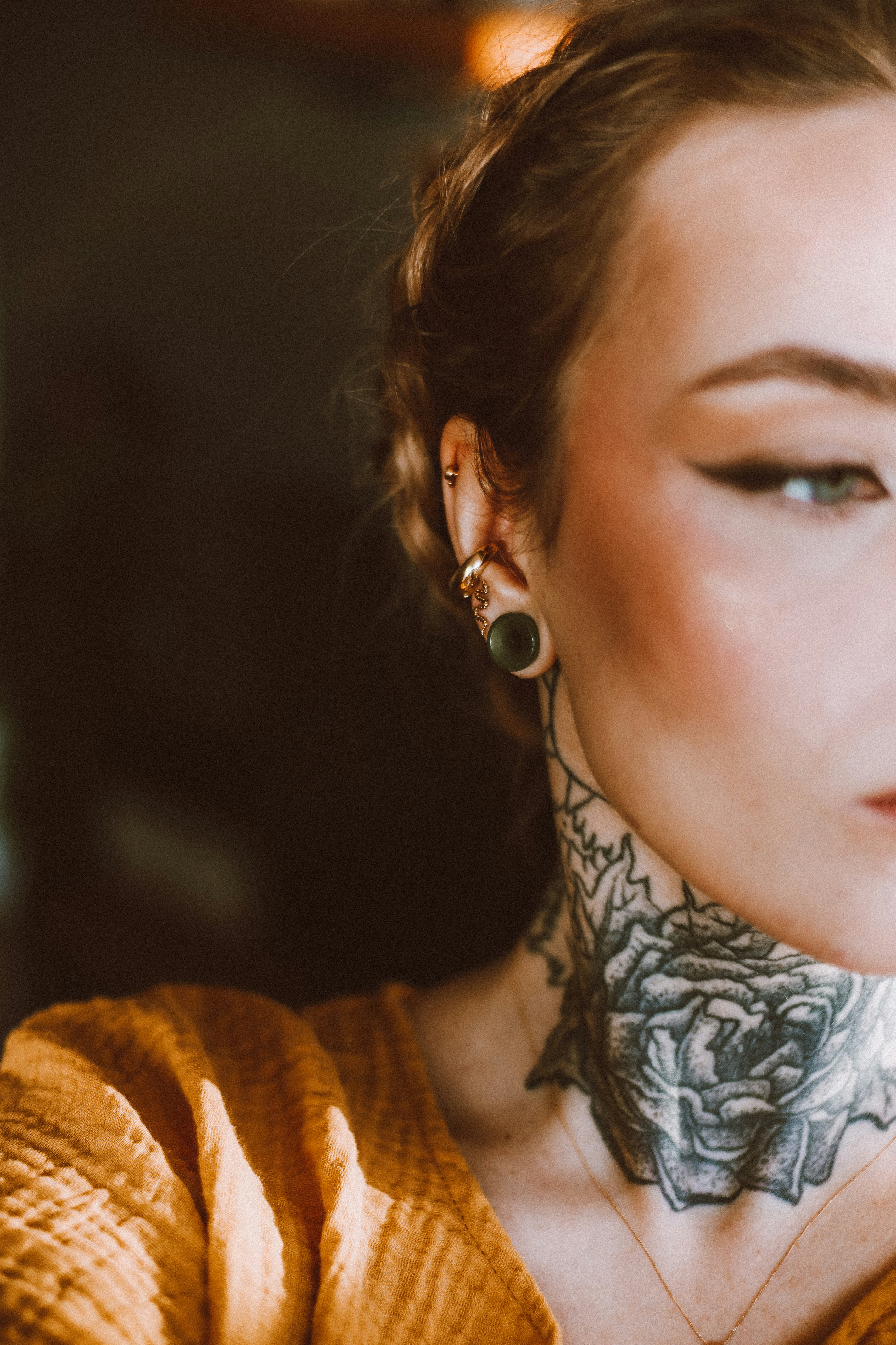 a woman with a tattoo on her neck