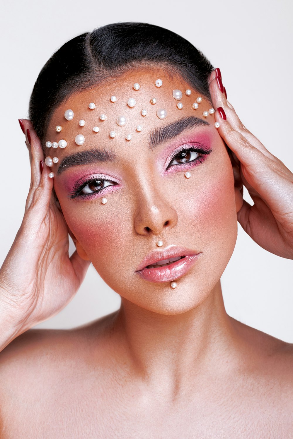 a woman with white pearls on her face