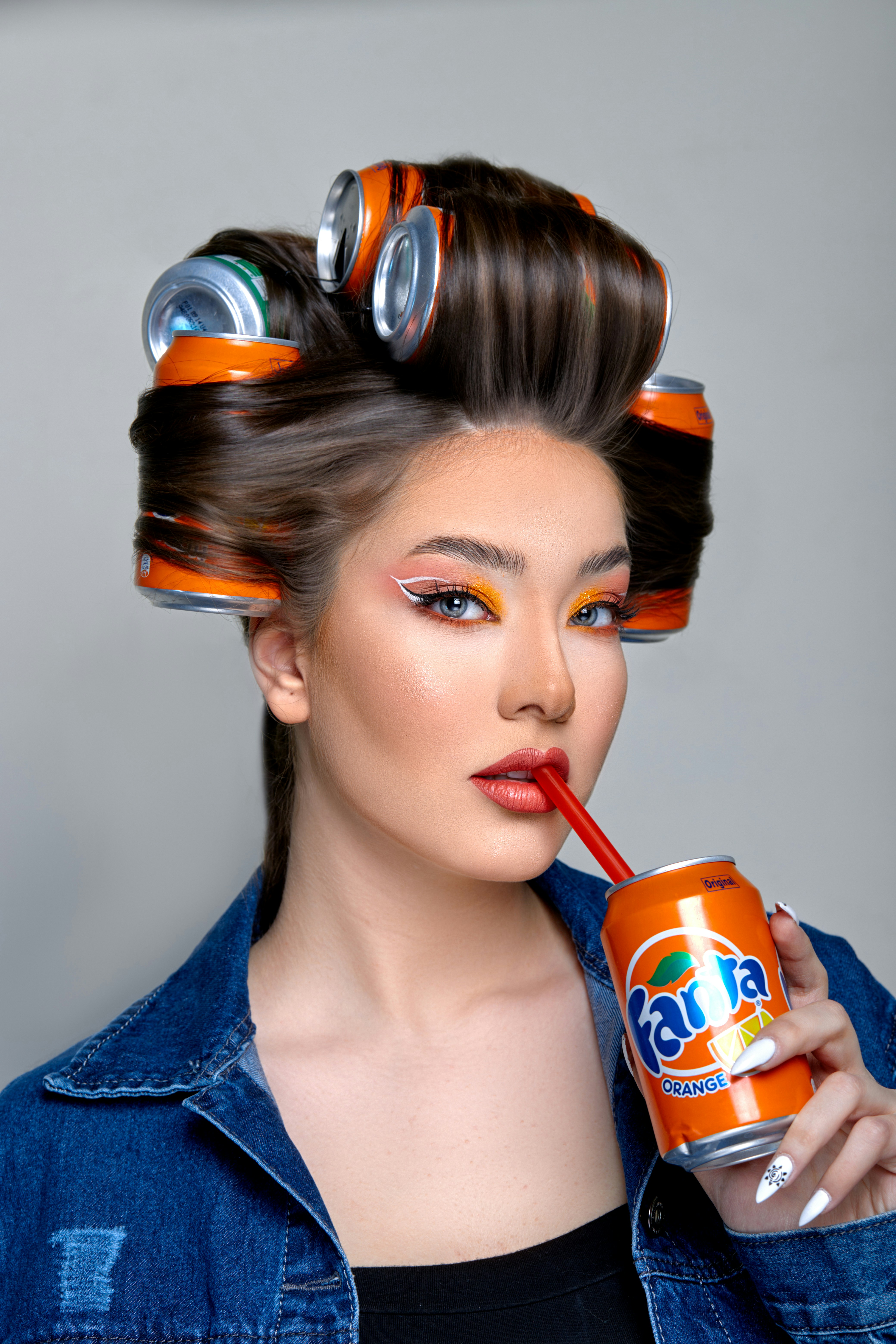 a woman with a can of soda in her hair