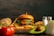 A juicy hamburger with lettuce, tomato, and cheese sits on a wooden board surrounded by crispy French fries. Fresh ingredients such as a whole avocado, sliced onion, a potato, and ripe tomatoes accompany the scene. A pair of salt and pepper shakers is positioned on the right side.