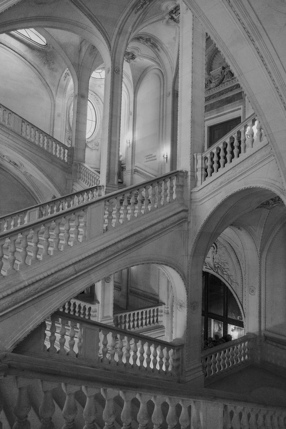 a black and white photo of a staircase in a building