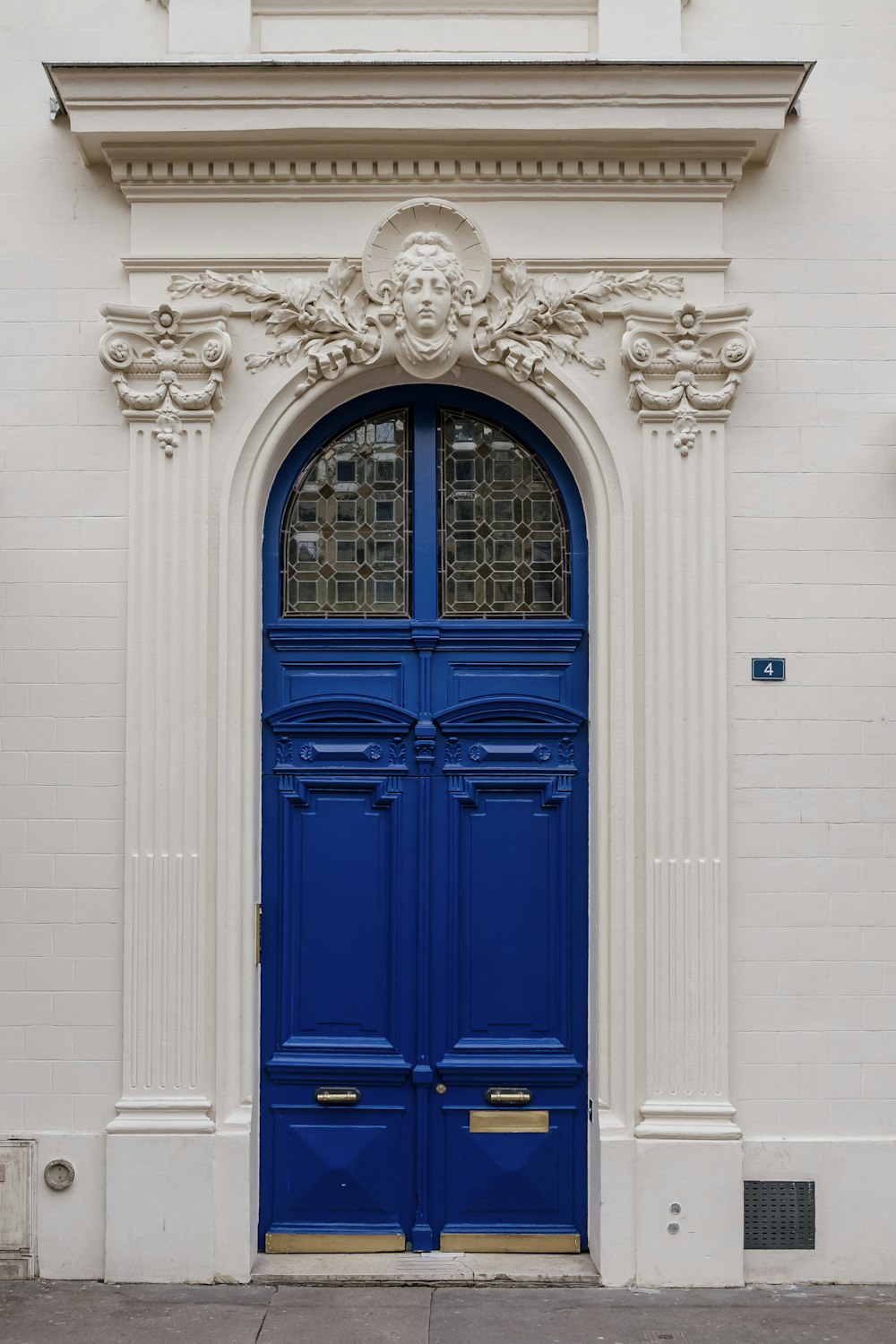 a white building with a blue door and window