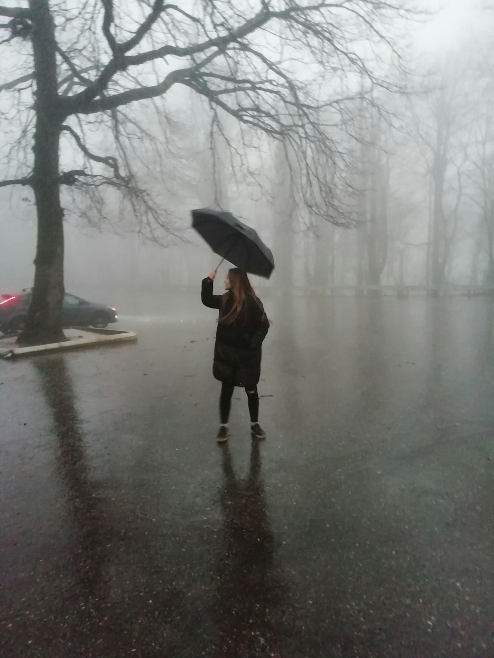 a woman holding an umbrella in the rain