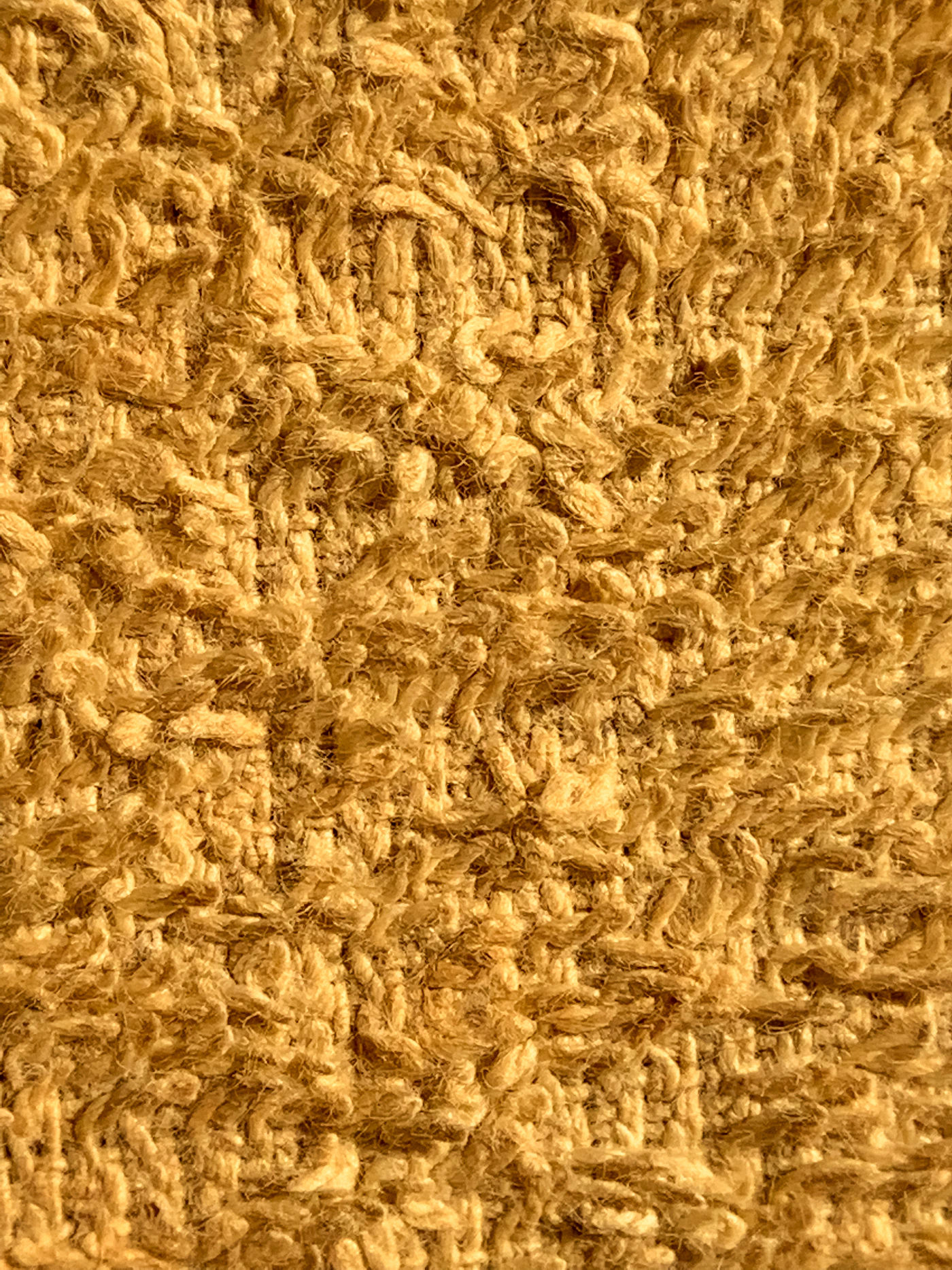 Close view of the intricate texture and pattern of a decorative carpet