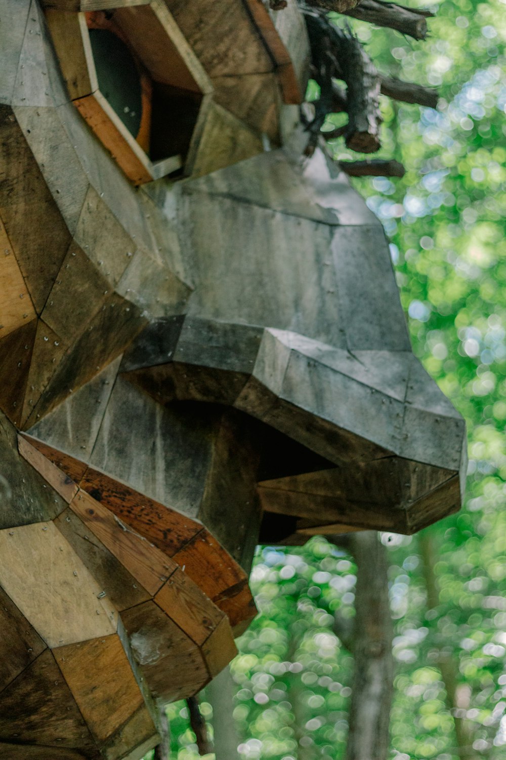 a wooden sculpture of a bear in the woods