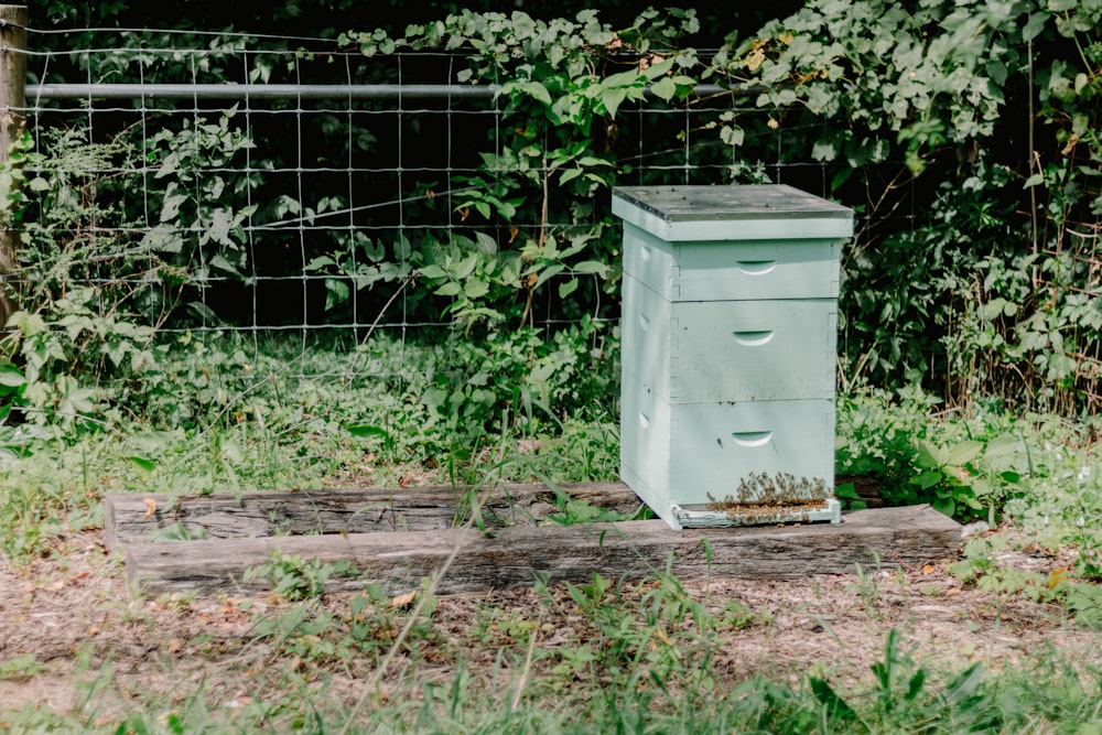 a beehive sitting in the middle of a field