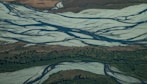an aerial view of a river running through a valley