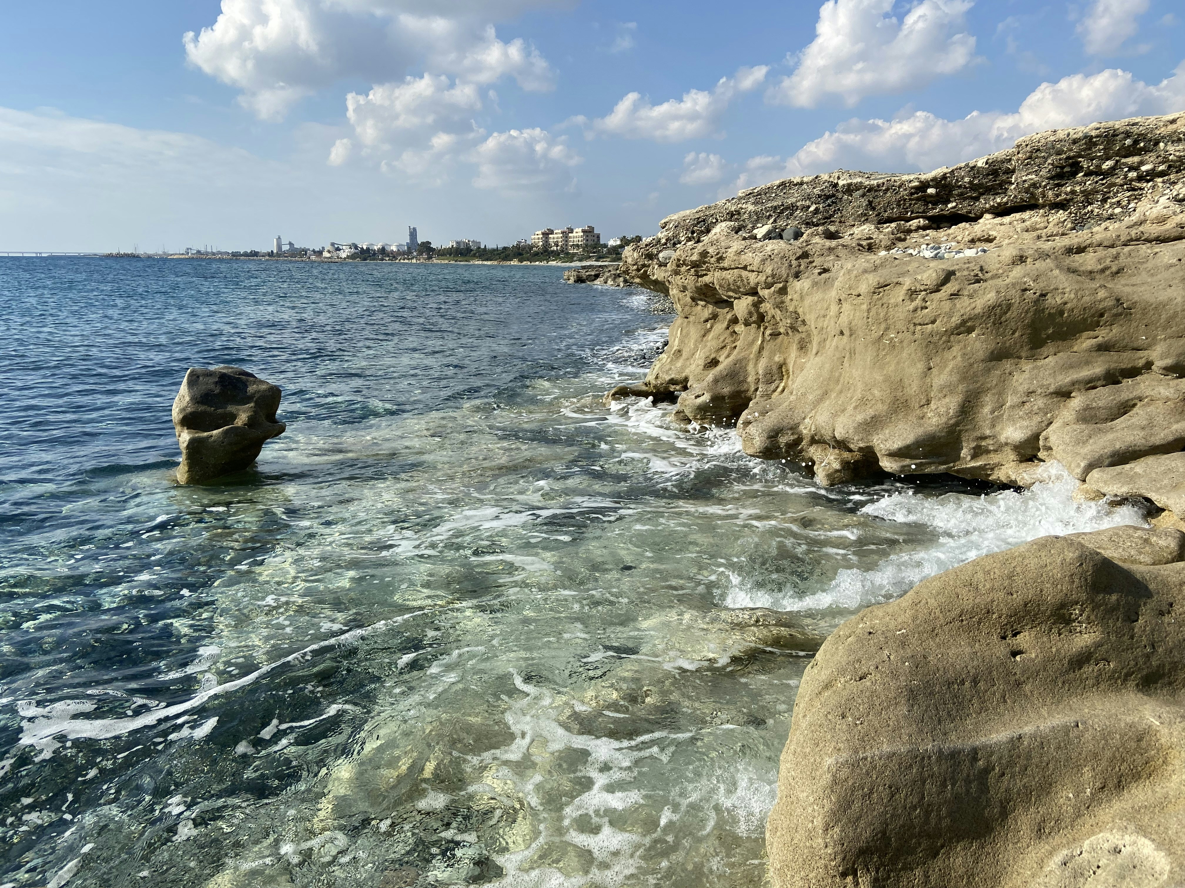 a body of water next to a rocky shore