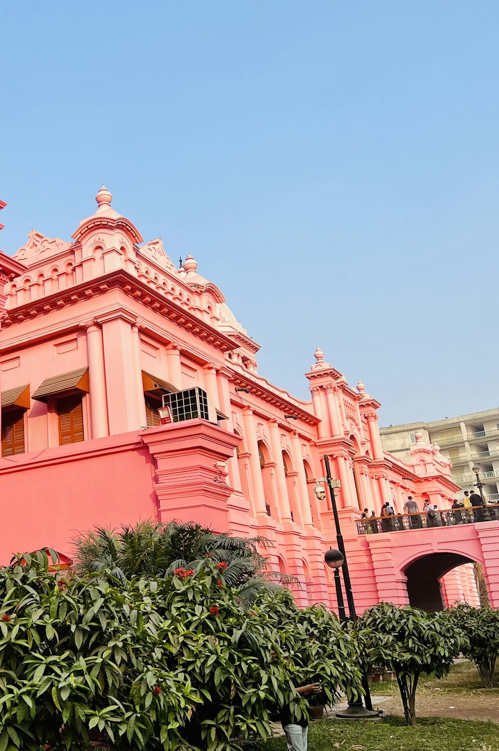 a pink building with a clock on the top of it