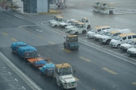Fleet of transport vehicles lined up ready for departure.