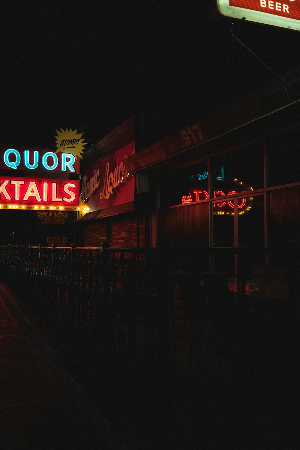 a neon sign is lit up in the dark