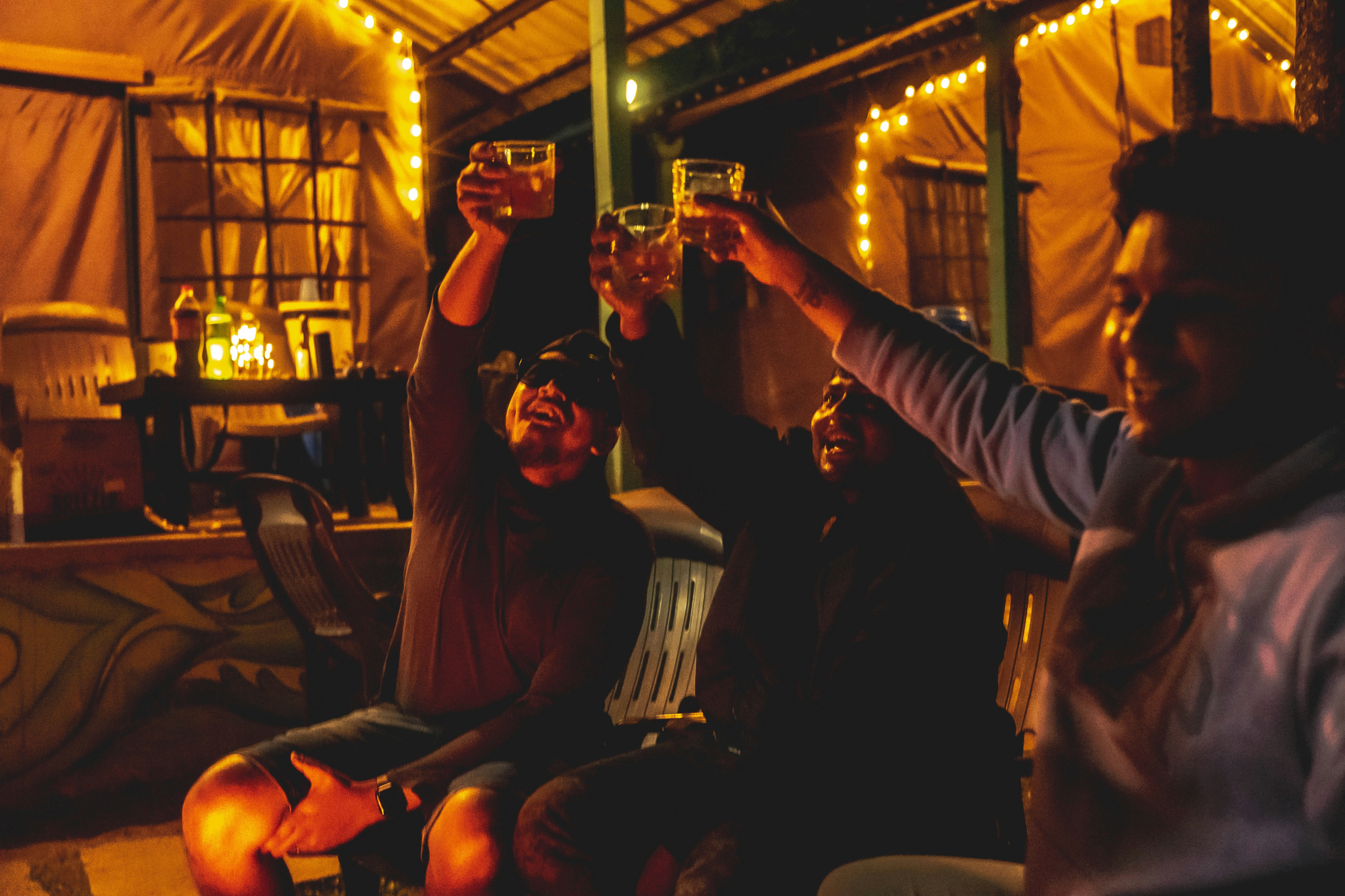 a group of men holding their glasses up
