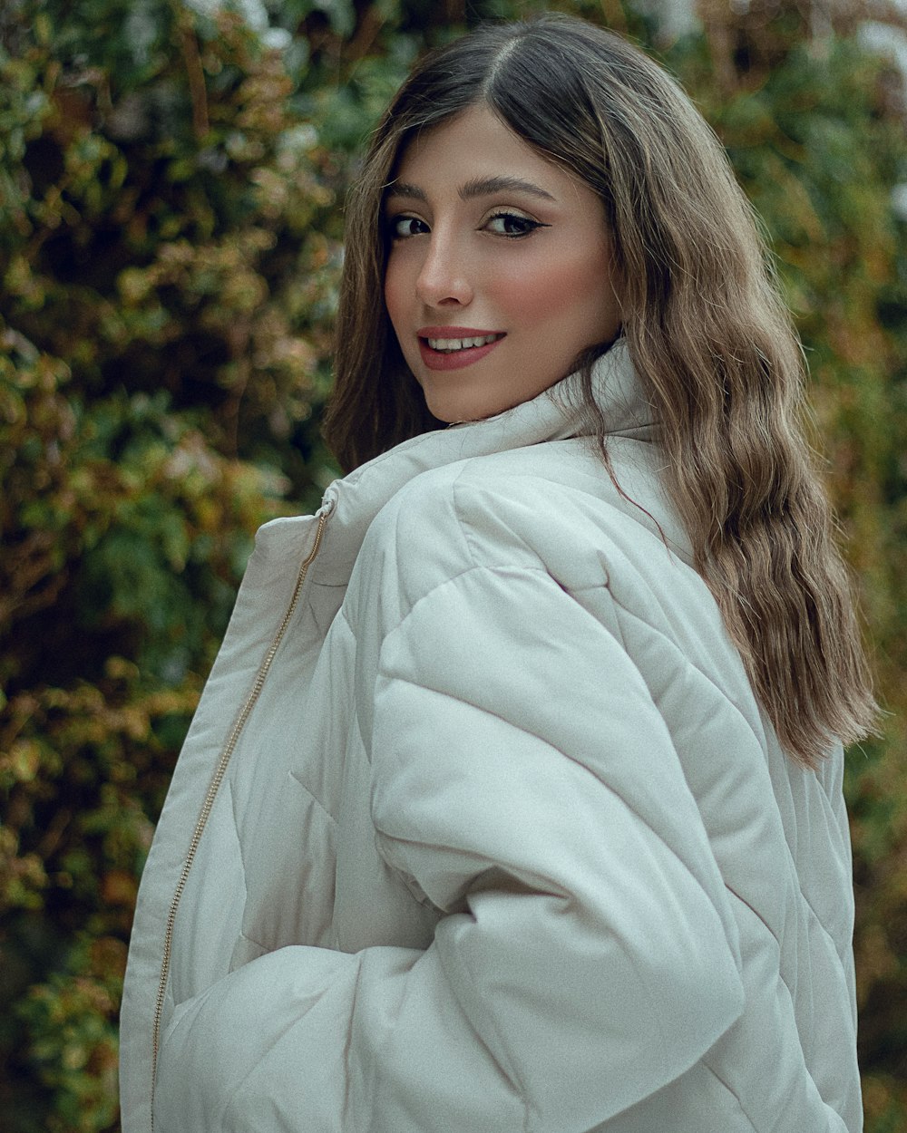 a woman in a white coat posing for a picture
