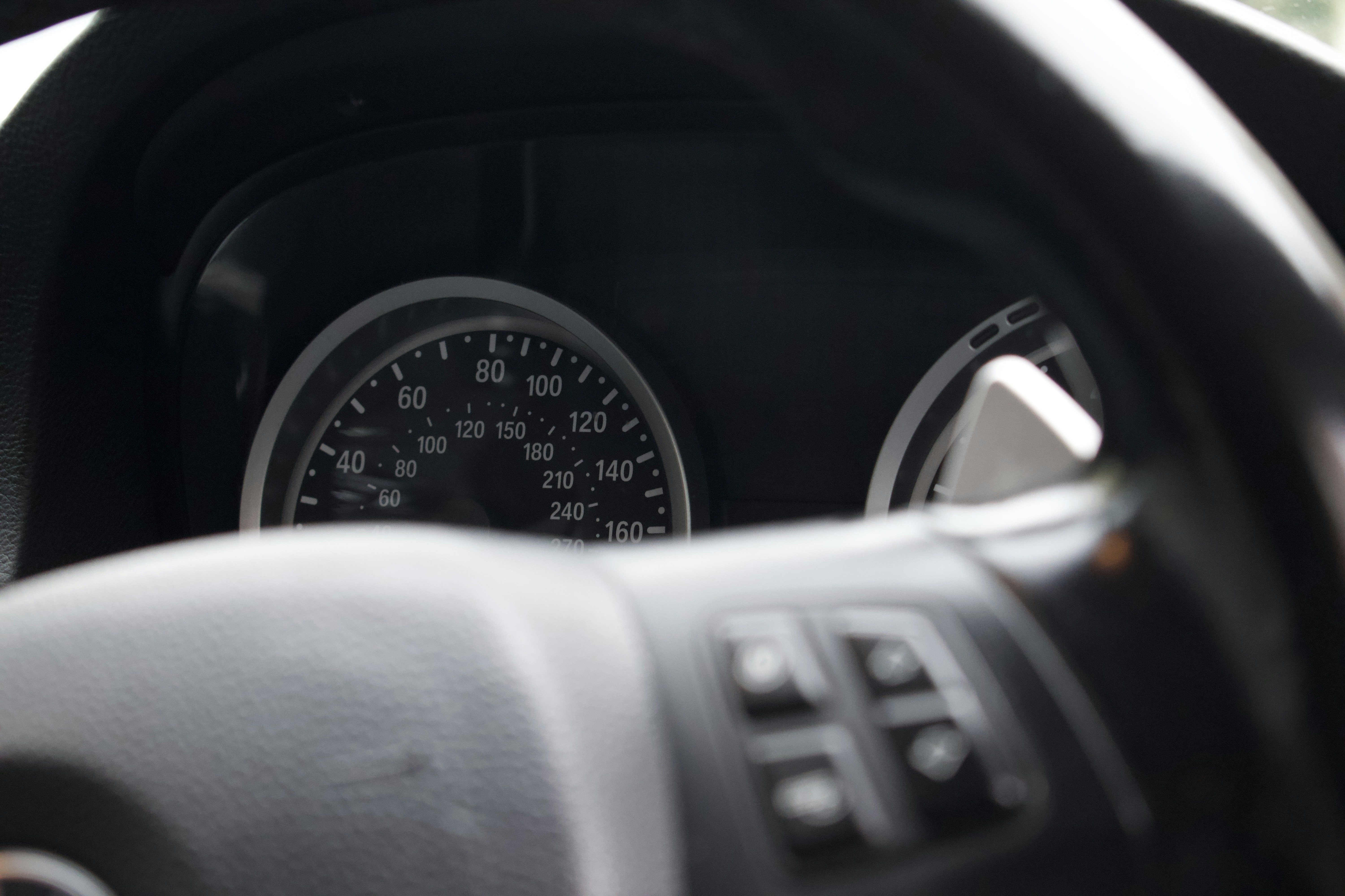 a close up of a car dashboard with a speedometer