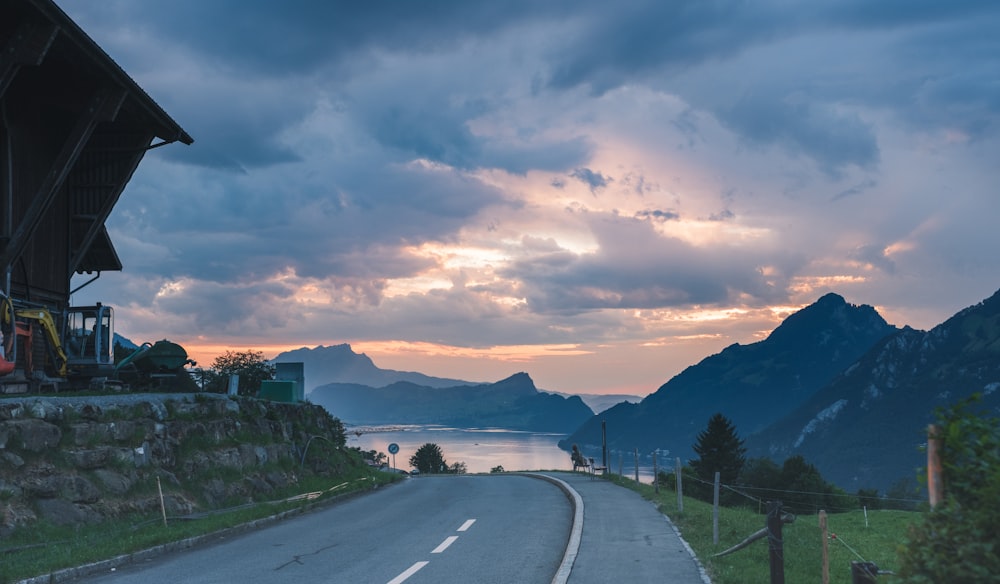 a scenic view of a road with mountains in the background