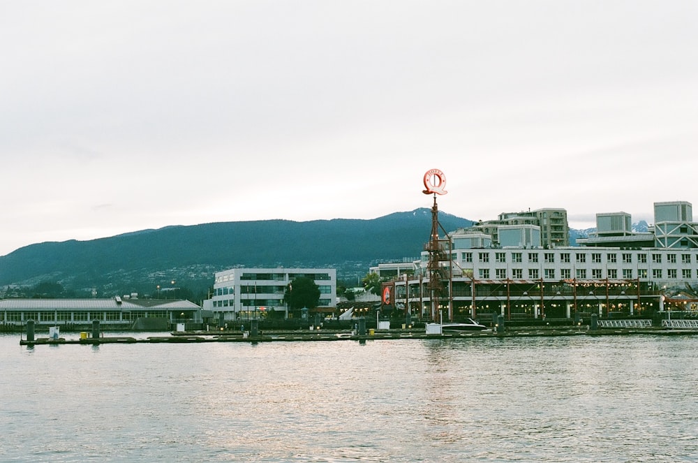 a large body of water with a building in the background