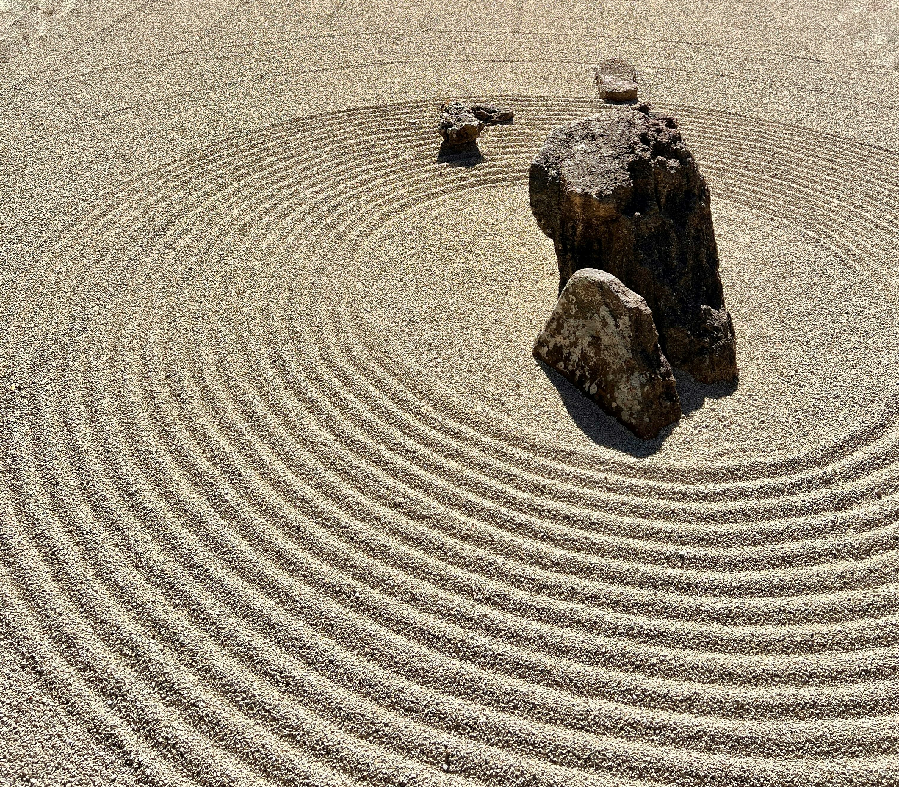 a rock sits in the middle of a circular rock garden