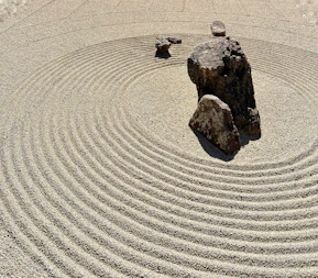 a rock sits in the middle of a circular rock garden