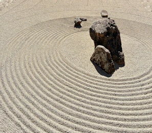 a rock sits in the middle of a circular rock garden