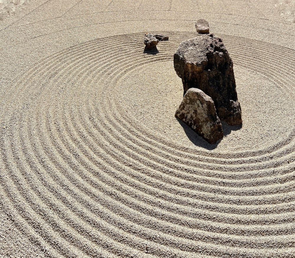 a rock sits in the middle of a circular rock garden