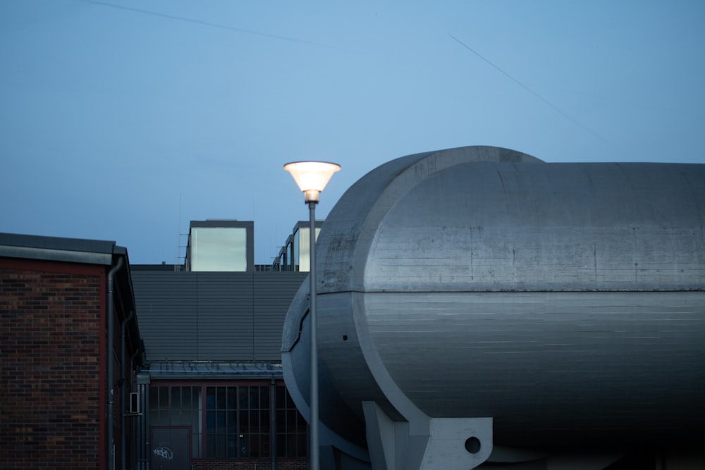 a street light next to a building with a sky background