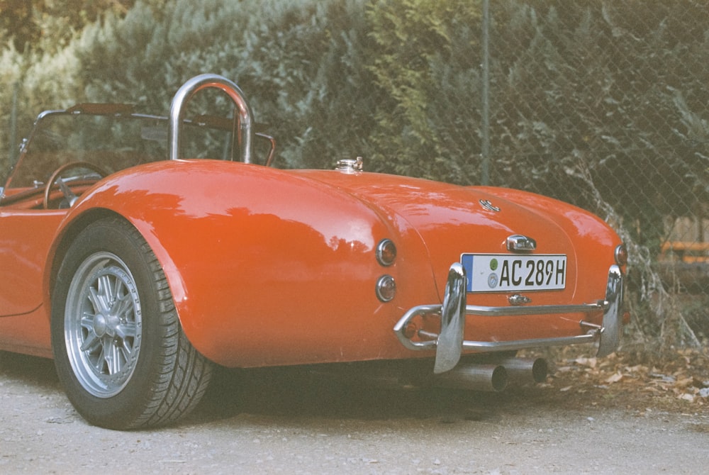 a red sports car parked on the side of the road