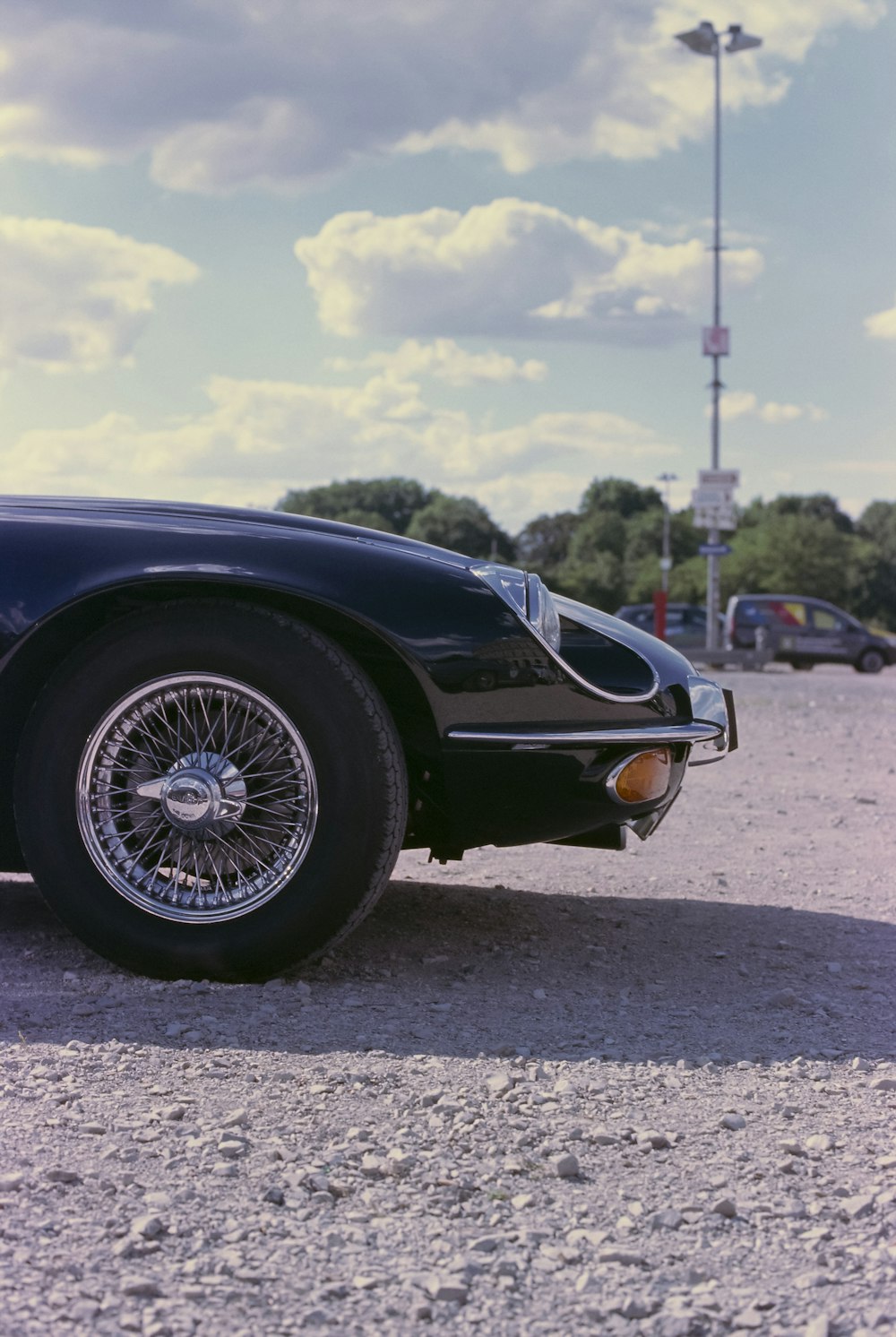 a black sports car parked in a parking lot