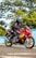 A satisfied customer riding their Honda motorcycle on the road.