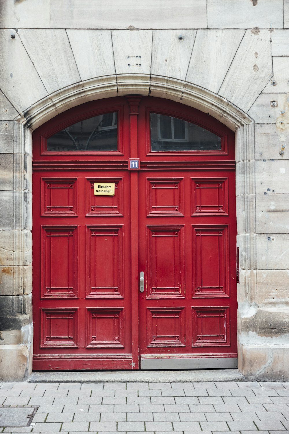 a red door with a sign on it