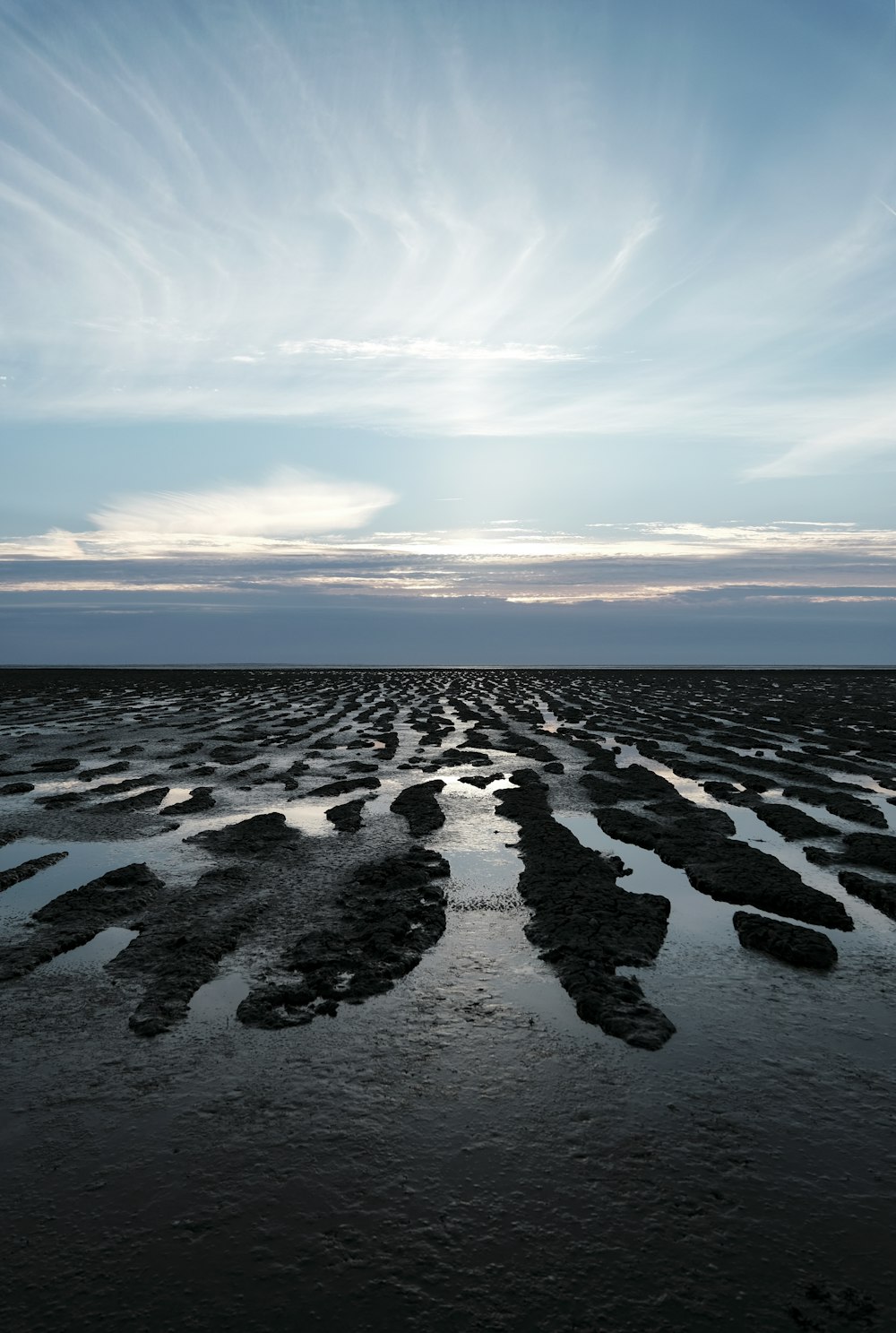 a large expanse of water with rocks in it