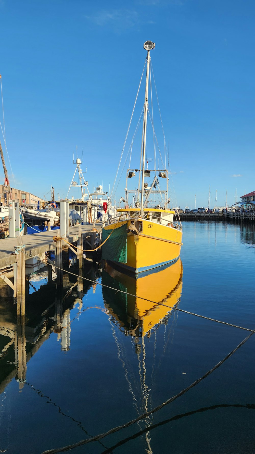 a yellow boat is docked at a dock