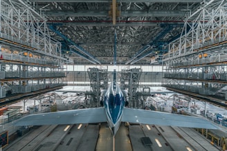a large jetliner sitting inside of an airport hangar