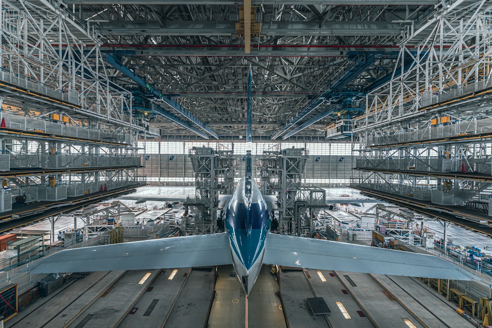 a large jetliner sitting inside of an airport hangar