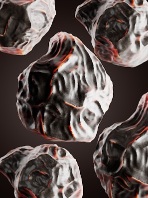 Multiple dark, textured rocks with red and white highlights are floating in a seamless pattern against a black background. The rocks have an irregular, organic shape and are depicted with detailed shading and coloring.